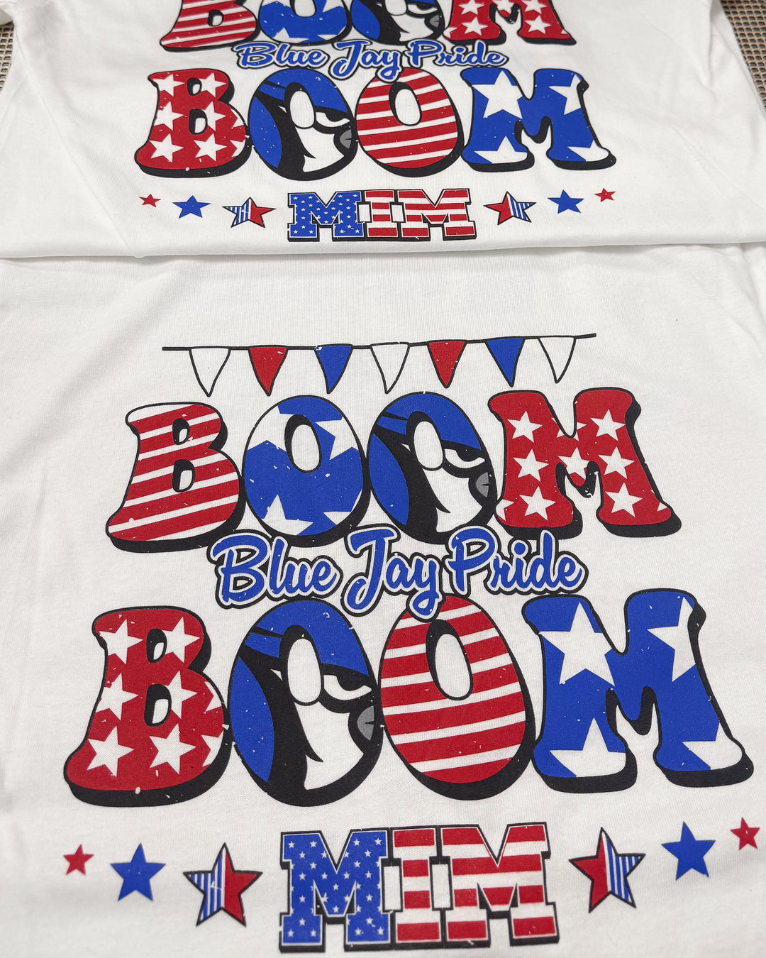 White shirt with 'Boom Boom Blue Jay Pride' text in red, blue, and white on a white background